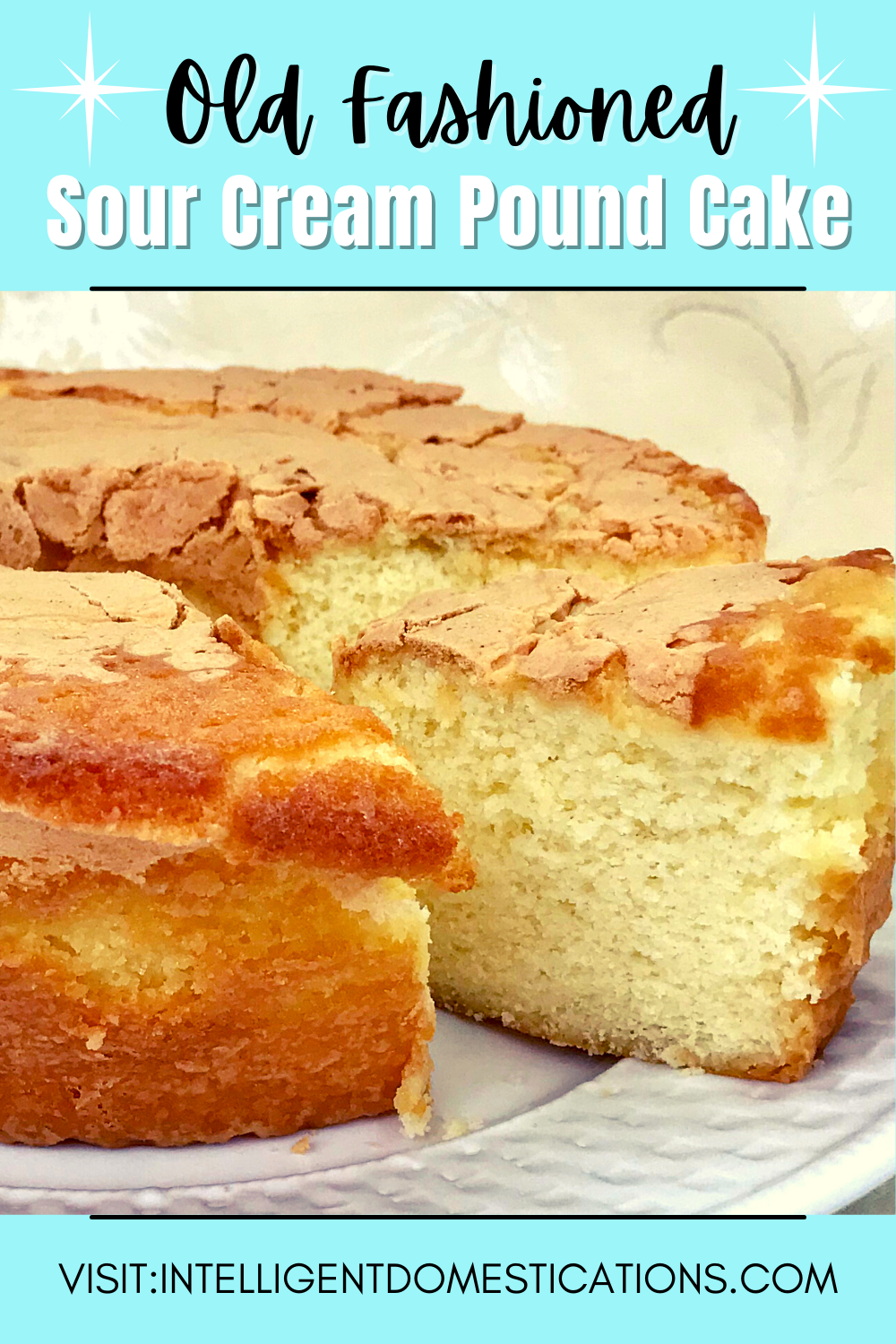 a pound cake on a white plate with on slice cut and slid out slightly revealing the moist inside