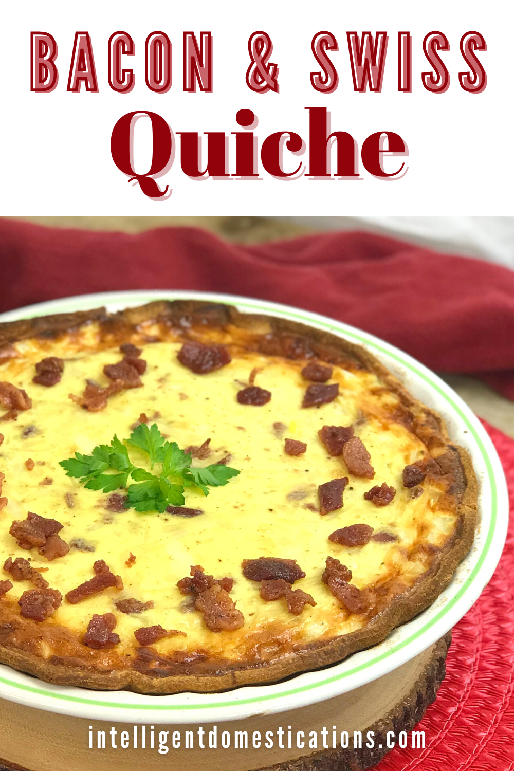 Quiche Lorraine in a pie plate on a table with a red cloth in the background