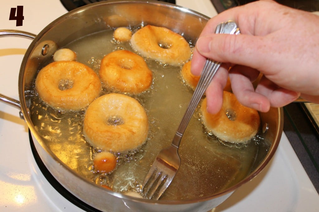 Frying the biscuit donuts.