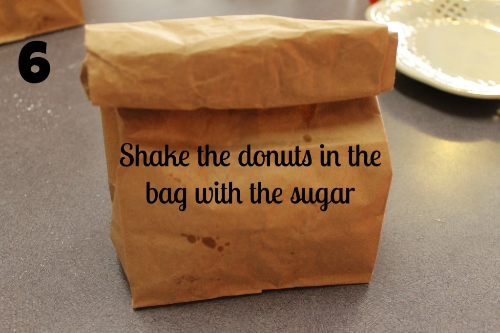 Shake the donuts in the sugar in brown bag.
