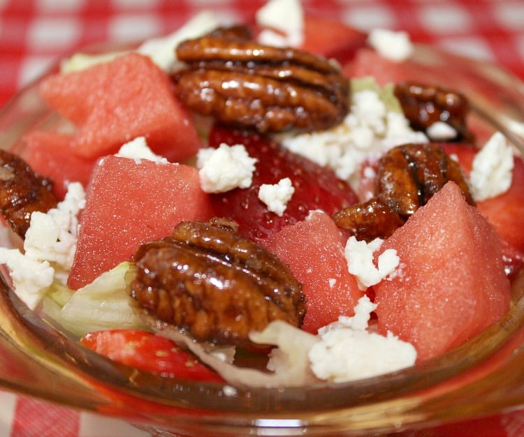Watermelon salad with feta and candied pecans served in a small bowl