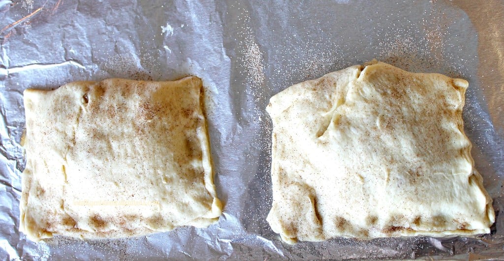 This 4 Ingredient Crescent Apple Turnover recipe will have your house smelling delicious and tickle your taste buds too. It's an easy recipe using Crescent rolls and apples drizzled with homemade icing. #crescentrolls #appledessert #fallfood stuffed crescent rolls pinched closed