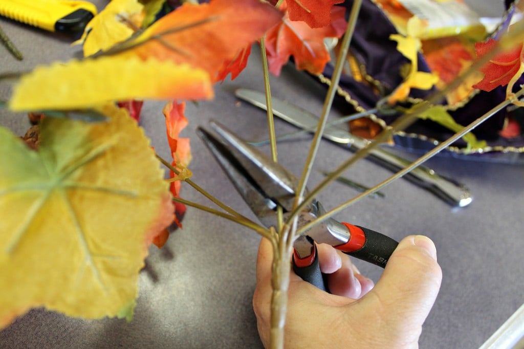 How to make a Scarecrow Centerpiece How To Make A Scarecrow Centerpiece. This fun centerpiece or tabletop Scarecrow is made completely with dollar store supplies. He's popping up from the leaves and keeping the candy corn safe. #diy #diyfall #falldecor #scarecrow #candycorn #dollarstore #dollarstoredecor