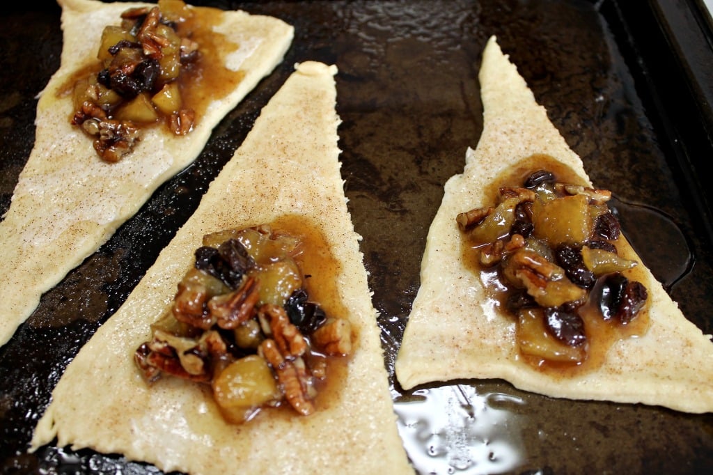 Place a dollop of the apple, pecan, raisin mixture inside of the crescent roll then gently roll up.intelligentdomestications.com