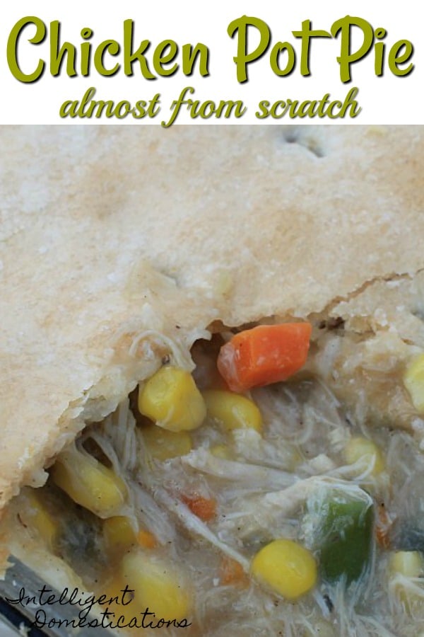 Homemade Chicken Pot Pie with top and bottom crusts. I like to cook the chicken from scratch for a delicious and packed with flavor Chicken Pot Pie. Only 8 ingredients. #Chickenrecipe #casserole Chicken pot pie with a big scoop removed revealing the chicken and vegetables inside