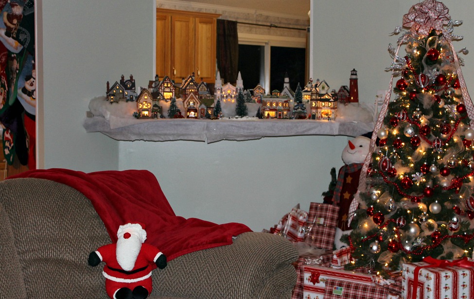 Living room with tree and villiage lit at night.Christmas Home Tour 2015.intelligentdomestications.com