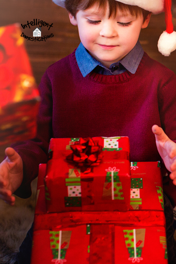 boy opening gifts all wrapped in the same paper