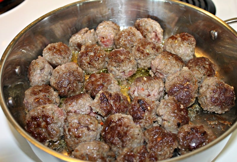 meatballs cooking in a large skillet