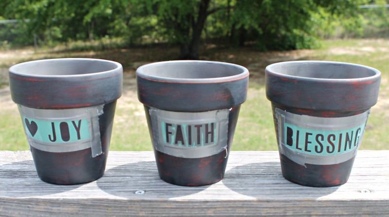 Clay pots with stensil taped into place