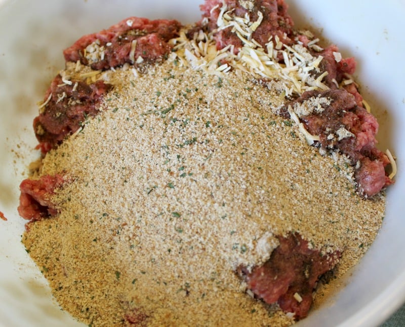 a bowl of meatball mixture with meat and dry ingredients