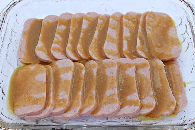 This easy recipe for Glazed Baked Spam has been gracing our dinner table for many years. It's a quick, easy and affordable weeknight entree with only 3 key ingredients. We serve it on a bed of rice.. #spam #recipe #weeknightdinner Make this easy 30 minute meal on busy weeknights. It's a yummy Spam recipe served on a bed of rice. How to make dinner with Spam. Cheap dinner ideas. Baked Spam Recipe. #spam #recipe #weeknightdinner