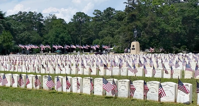 Volunteers place America flags at each and every headstone at Andersonville, Ga. jpg