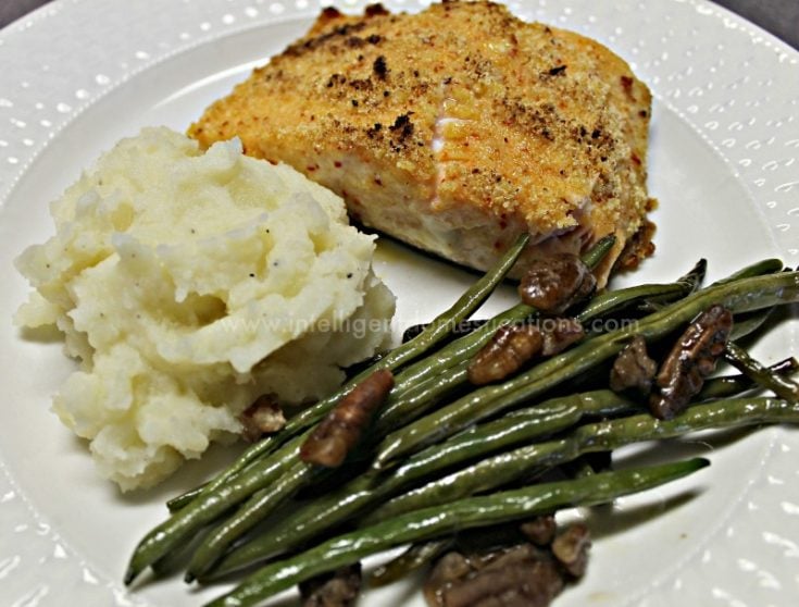 Make this yummy recipe for Parmesan crusted Salmon. It makes a delicious weeknight meal or special occasion meal. We make ours in the iron skillet and serve restaurant quality side dishes. #salmonrecipe #weeknightmeal #ironskilletrecipe