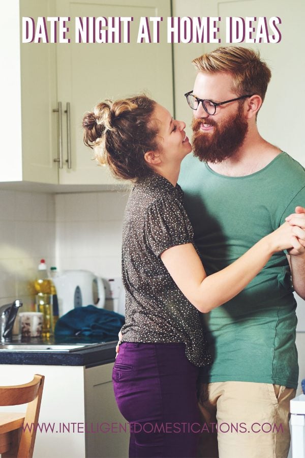 A Couple slow dancing in their kitchen for a date at home event.