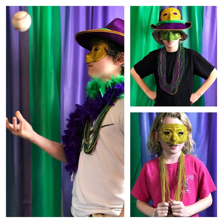 Family Friendly Mardi Gras Party Ideas. It's all about the food which is traditional to Mardi Gras and the New Orleans celebration. Homemade Biegnets, King Cake and a Shrimp Boil create a delicious party. #mardigras #NOLA #FatTuesday People posing in a Mardi gras party photo booth