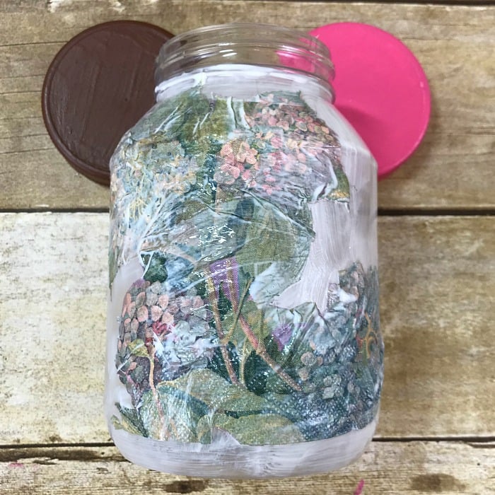 Decoupage a pretty paper napkin onto a mayonnaise jar to create craft room storage containers