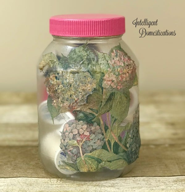 Decoupage a pretty paper napkin onto a mayonnaise jar to create craft room storage containers