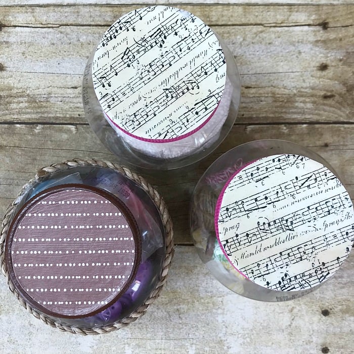 Repurpose mayonnaise jars into pretty craft room supply storage containers. Craft room organization. Repurpose mayonnaise jars. Use pretty craft paper to decorate lids of upcycle mayonnaise jars #craftroomorganization