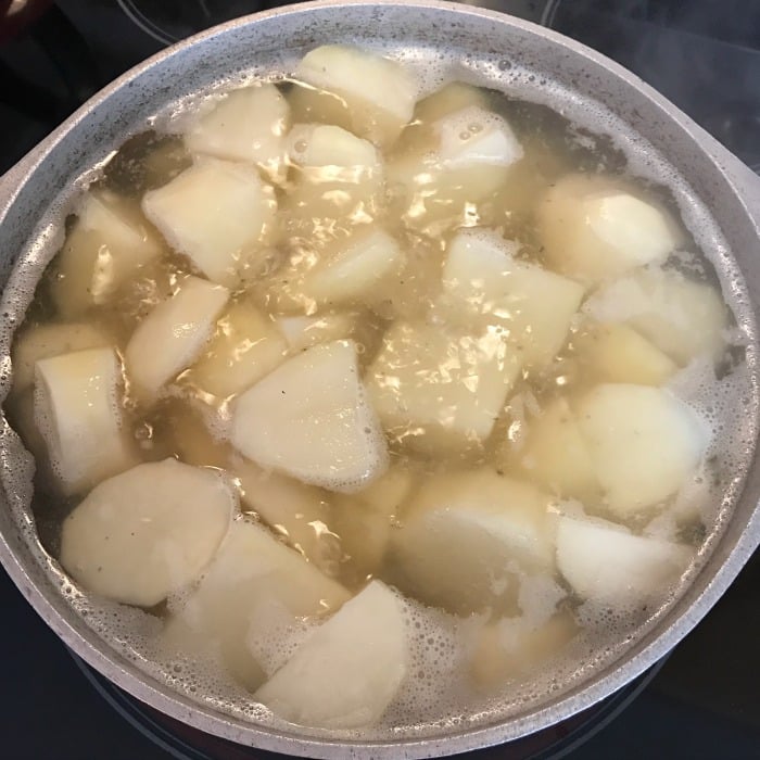 Southern Potato Salad recipe. My recipe is just like Mom's and her Mom too with little bits of fresh potatoes and lots of flavor. Potato Salad is a summer side dish must have for picnics and family gatherings. How to make potato salad from scratch. #sidedish #potatosalad #summerfood #picnicfood potatoes boiling in a pot