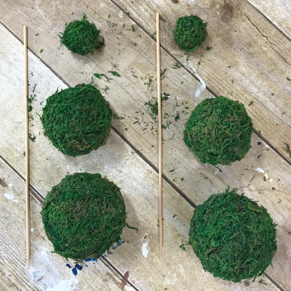 Cover your foam balls with moss using hot glue. How to make a mini moss ball topiary using Dollar store supplies. Blue and White Moss Ball Topiary DIY project. Make your own blue and white decor vignette pieces. #mossballs #minitopiary #diytopiary #diydecor #dollarstorecraft