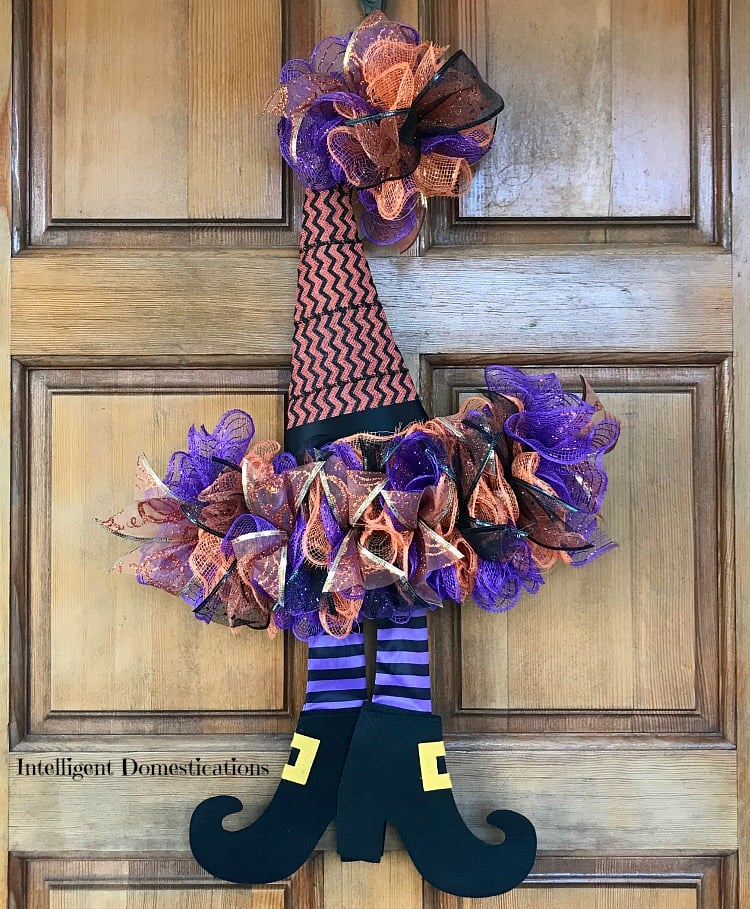 How To DIY A Witches Hat Wreath for Halloween decor. This Halloween wreath is made using Deco Mesh and a witches hat wreath form from the dollar store. This Witch wreath is a dollar store decor project. #halloween #witchhatwreath #halloweenwreath #diy #diywreath #doorhanger #HalloweenDecoMesh