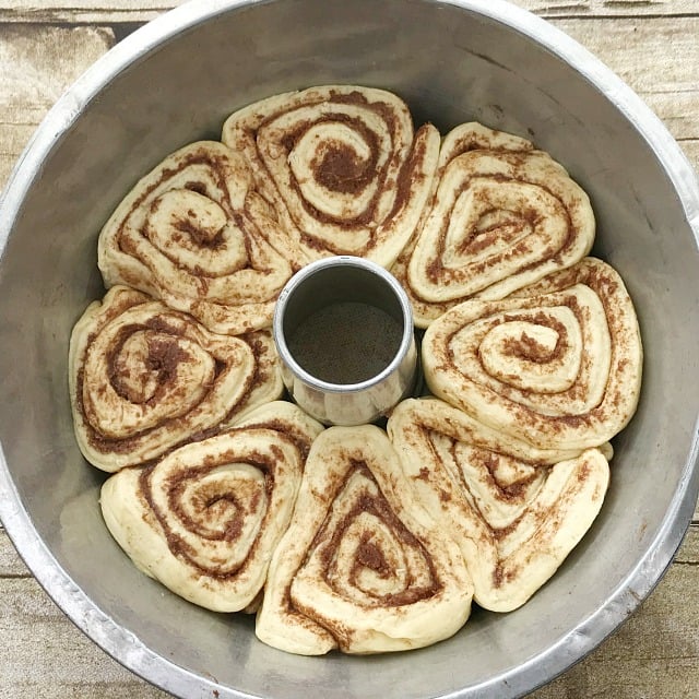 Raw cinnamon rolls placed into the bottom of a Tube Pan for baking