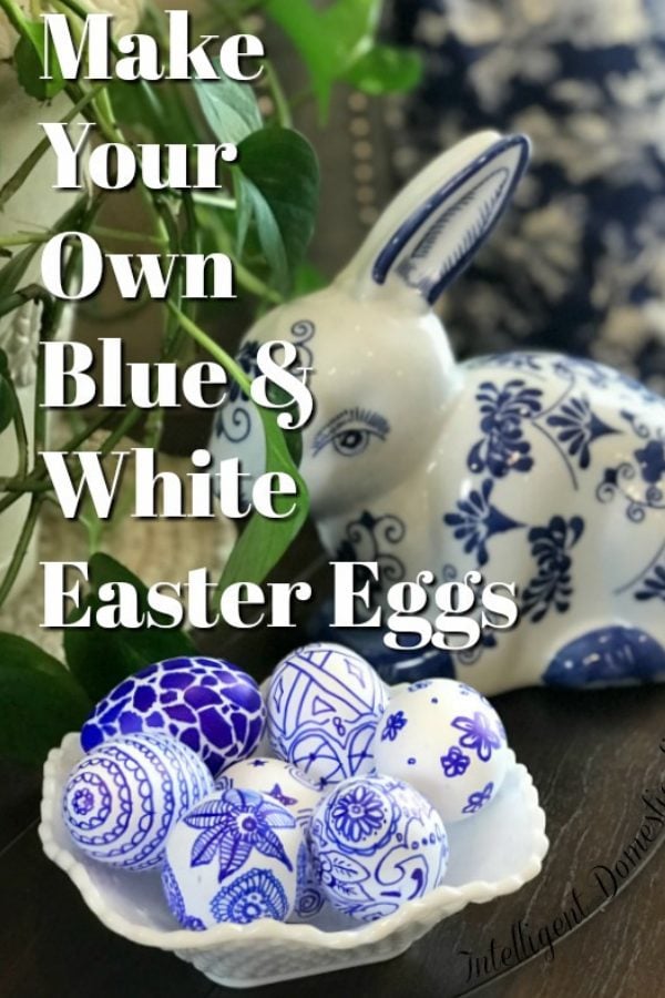 Blue and White decorated Easter Eggs in a white dish next to a Blue and White bunny by a green plant on a table