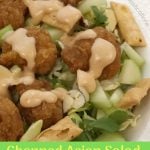 Asian Salad in a bowl with dressing being poured over it