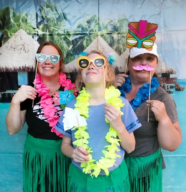 Our Backyard Luau Party was the most fun party! We set the mood with Tiki torches, Hibiscus flowers, Tropical leaves, a Tropical Cabana photo banner and a few more Tropical touches. All the details including where to buy the supplies are included. #backyardluau #luauparty #tropicalparty