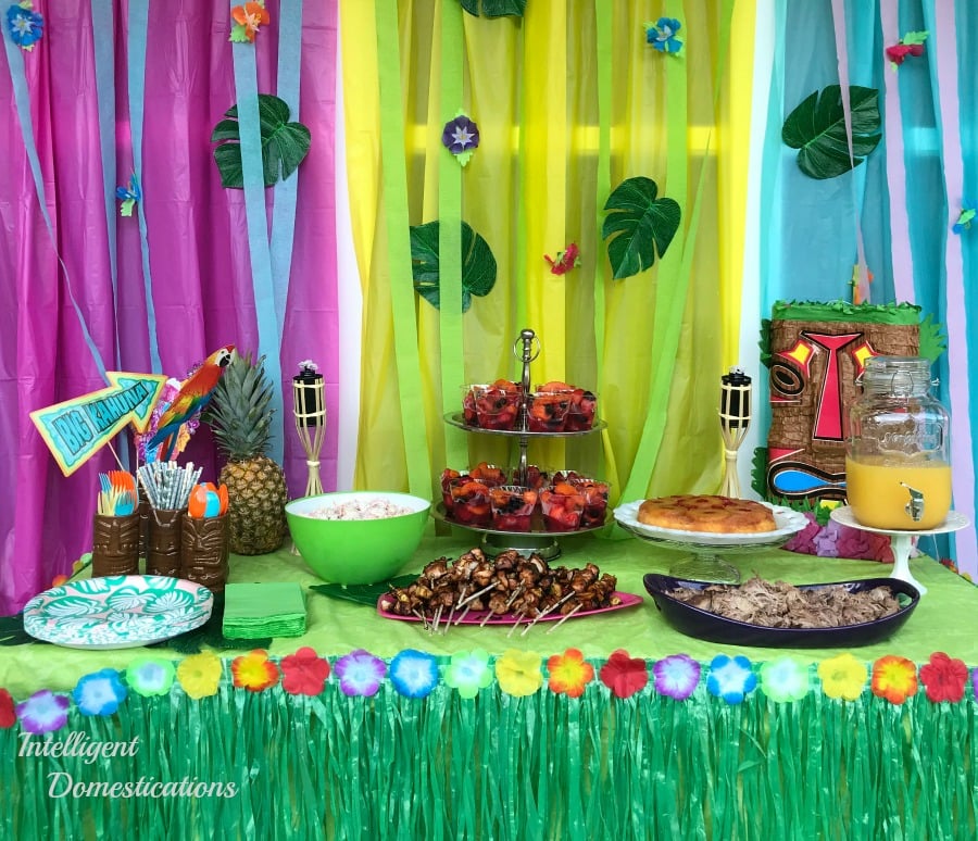 Luau party buffet table with lots of food