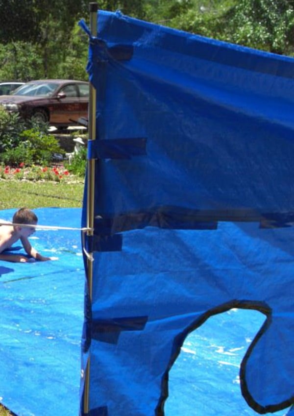 This one DIY Water Tarp Game will keep the kids busy with backyard summer water activities for hours! It's versatile for playing in the water. Play Water Balloon games, Water Bomb Target competitions. Pool Noodle Sword Fighting and a Slip and Slide surface and even use the Target Backdrop as a Photo spot! #watergames #summergames #outdoorplay This one DIY Water Tarp Game will keep the kids busy with backyard summer water activities for hours! It's versatile for playing in the water. Play Water Balloon games, Water Bomb Target competitions. Pool Noodle Sword Fighting and a Slip and Slide surface and even use the Target Backdrop as a Photo spot! #watergames #summergames #outdoorplay