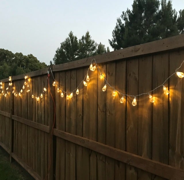 Outdoor string lights on a fence