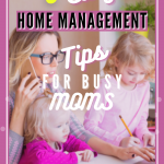 A Mom with a baby on her lap and a small child next to her while she is working online on a laptop