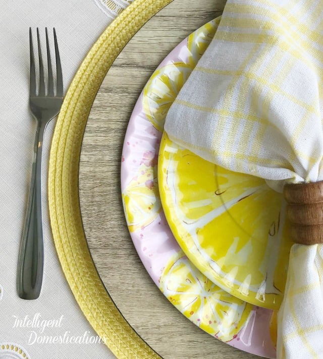 We created this Simple Lemon Tablescape for a late summer romantic soiree for two. My table decorations are simple and Mason Jars were perfect for our lemon infused water. Yes, those are Melamine dishes found! #lemontablescape #yellowtablescape #tabledecorations