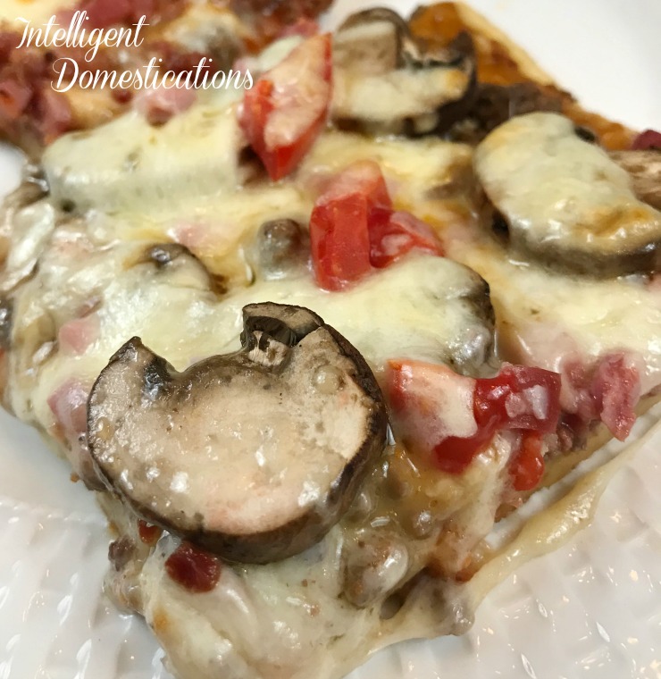 Easy Homemade Three Meat Pizza recipe.Topped with Roma tomatoes and Baby Bella mushrooms