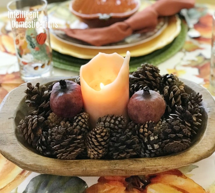 Create a quick easy and free Autumn centerpiece using a bowl you already have along with a few pine cones and a candle you can light. #Autumn Simple Autumn Table Centerpiece with candles and pine cones