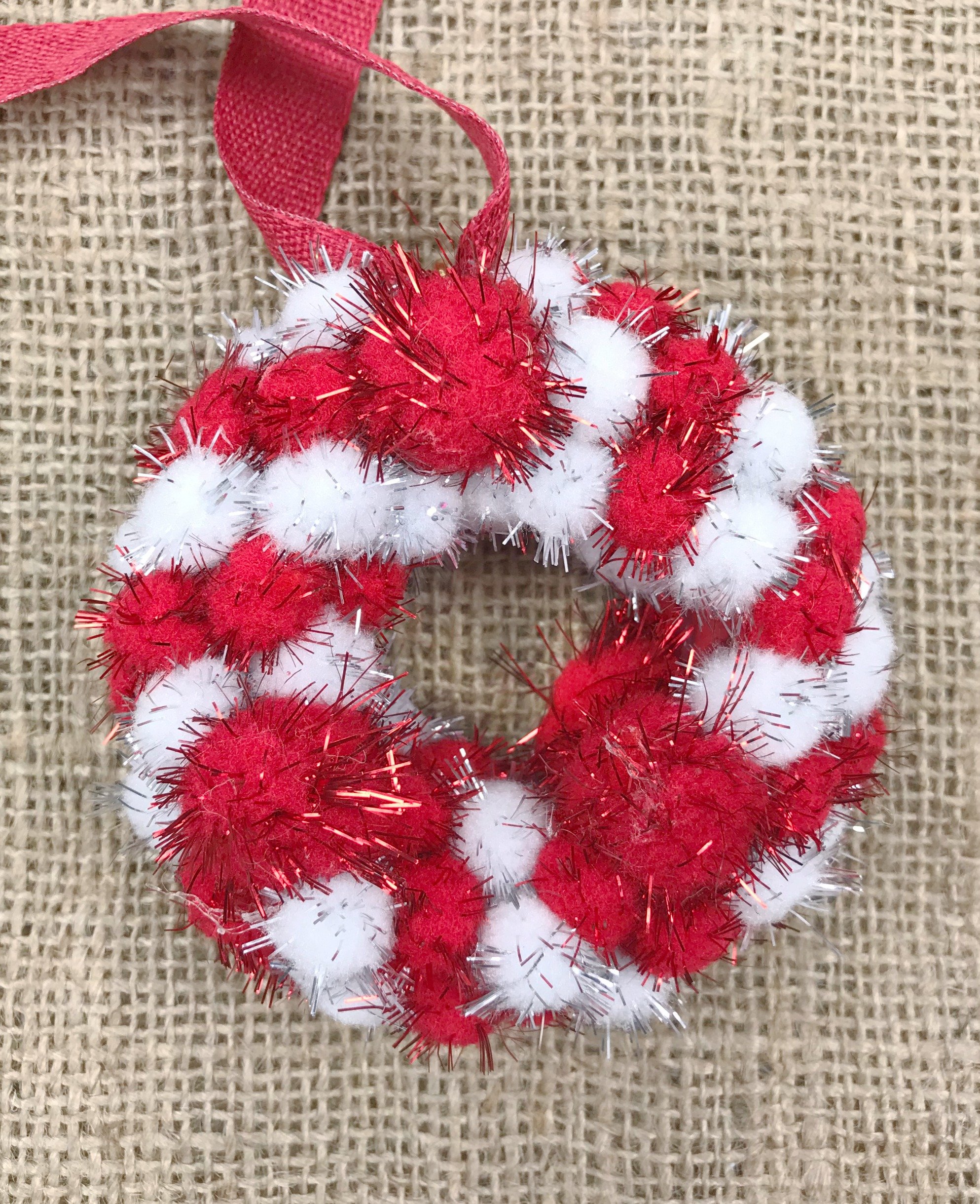 You can make this adorable Mini Pom Pom Wreath Ornament for your Christmas Tree. This is an easy and inexpensive Christmas craft using few supplies. #Christmascraft You can make this adorable Mini Pom Pom Wreath Ornament for your Christmas Tree. This is an easy and inexpensive Christmas craft using few supplies. #Christmascraft