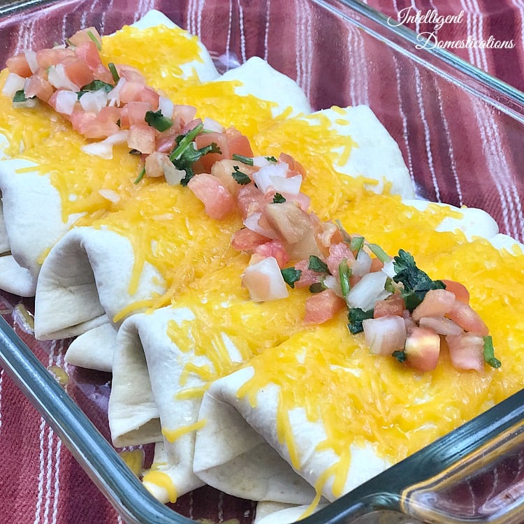Beef and Bean Burritos covered in melted cheese with Pico de gallo on top