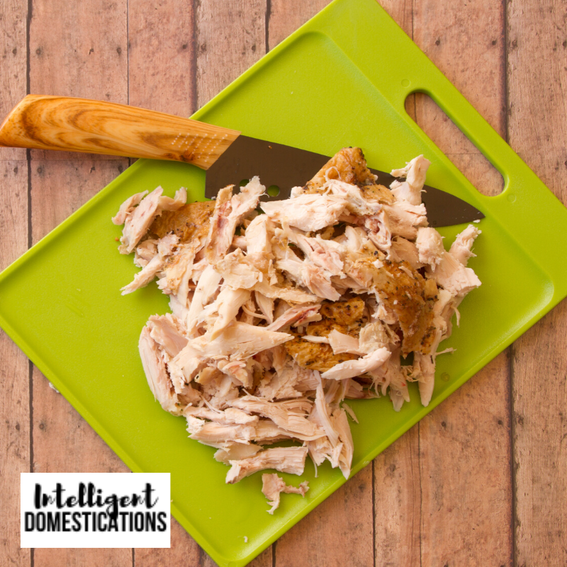 Chopped Rotisserie Chicken on a cutting board next to a knife