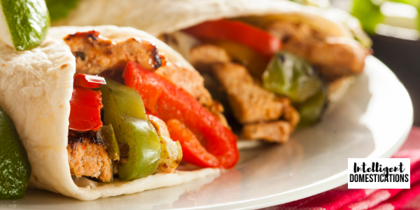 Homemade Rotisserie Chicken Fajitas weeknight meal idea. Drizzle with homemade Cilantro-Lime Sauce, recipe included. Chicken Fajitas served on a white plate