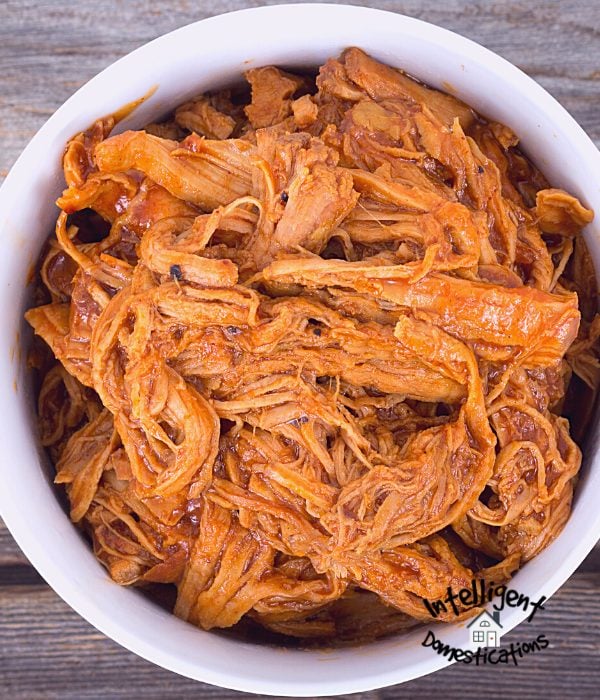 This Crock pot pulled pork for BBQ recipe is super easy with only a few ingredients. Put it in the slow cooker and forget it for hours.This is a must have easy recipe to feed a crowd when you are entertaining. #bbqpork #slowcookerpork #porkbutt #partyfood