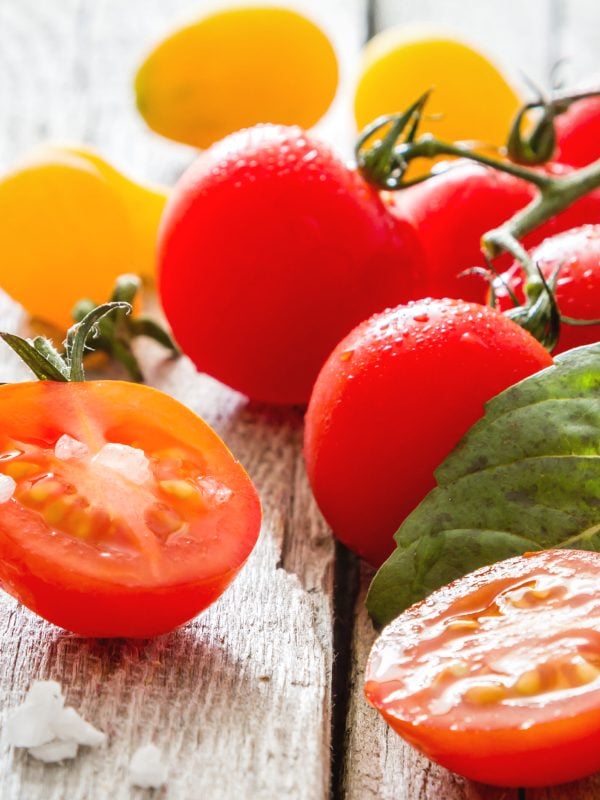 Rinse your grape tomatoes. Cut some in half and leave some whole for this Green Bean Salad recipe