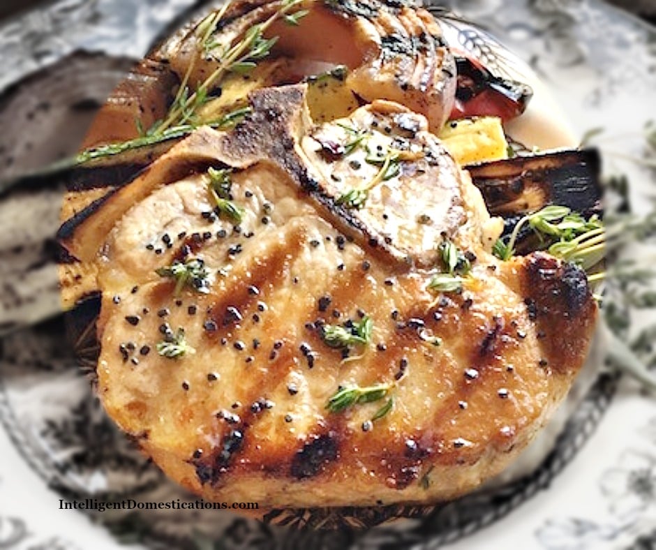 Grilled Pork Chops rubbed with fresh herbs. Bone in. Easy summer grilling recipe for a quick weeknight meal. #grilledporkchops #porkchops #summergrilling