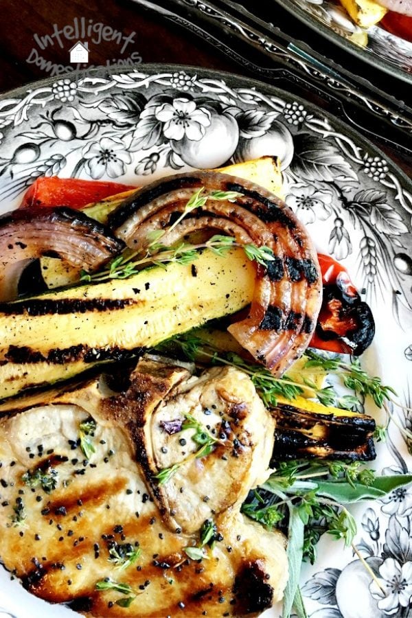 Grilled Pork Chops rubbed with fresh herbs. Bone in. Easy summer grilling recipe for a quick weeknight meal. #grilledporkchops #porkchops #summergrilling