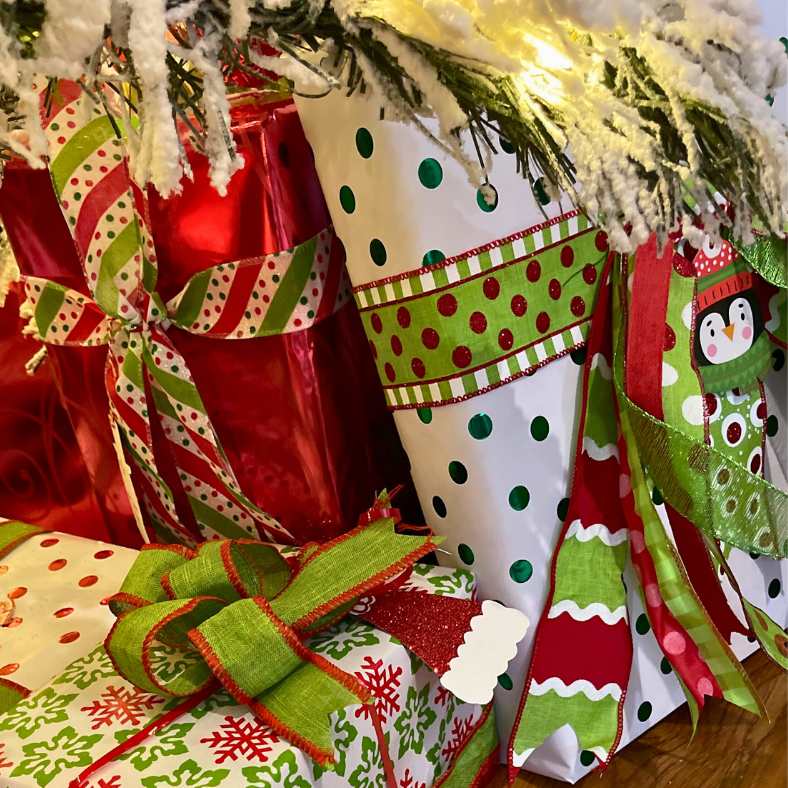 Christmas gifts wrapped with pretty paper and bows under the Christmas tree