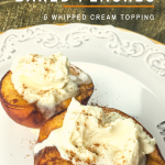 Baked peach halves with whipped cream on top on a white plate