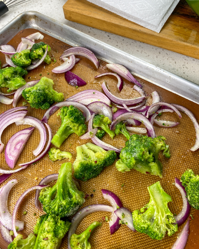 Broccoli and onions on a baking pan
