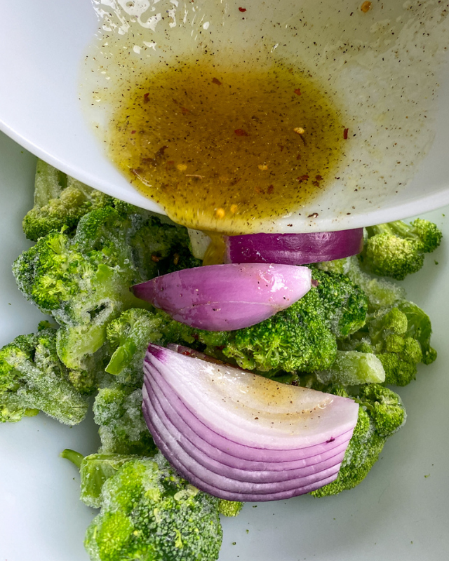 broccoli and red onion with a sauce