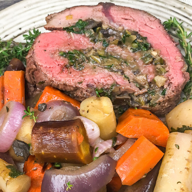 Spinach and Mushroom Stuffed Beef Tenderloin with vegetables