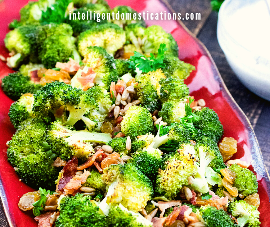 Broccoli Salad with bacon served in a big red dish